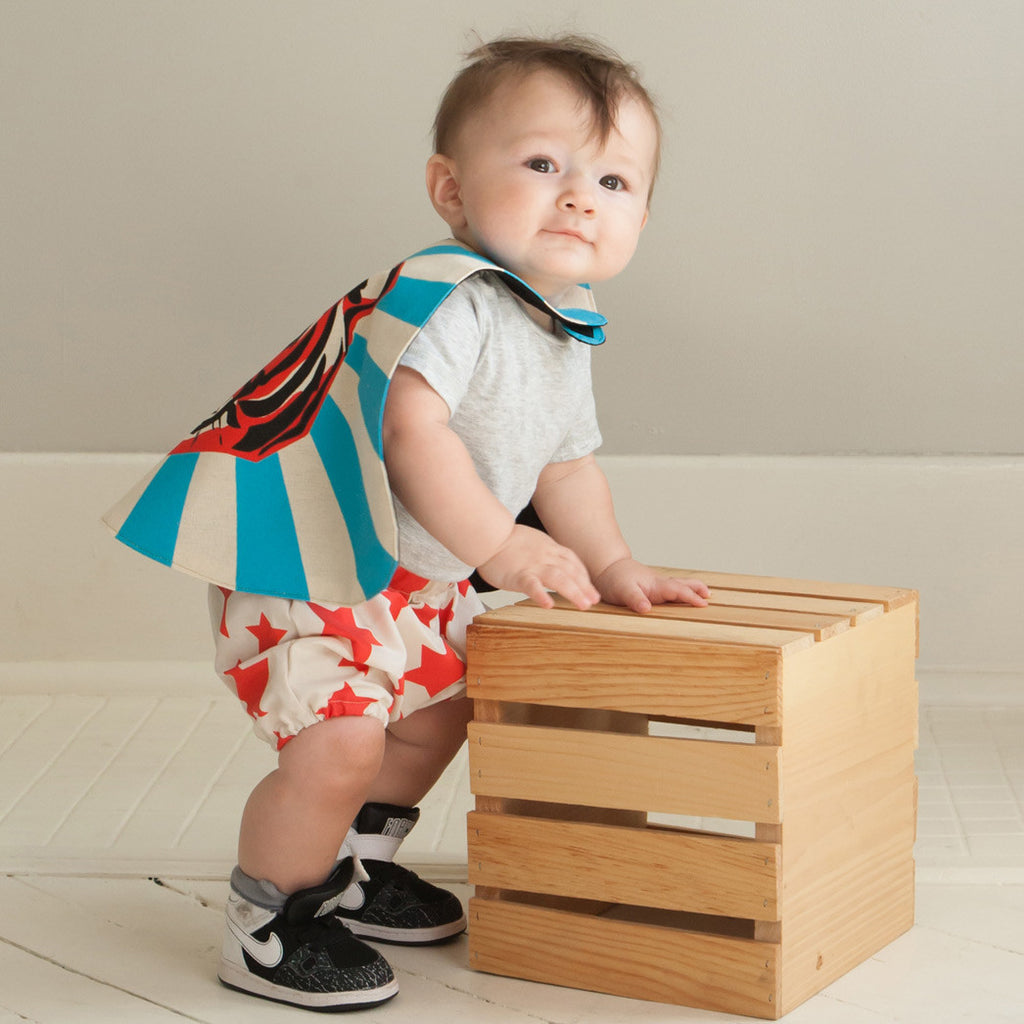 child superhero cape and bloomers climbing on crate lovelane designs